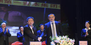 Vince Badalati,applauding at rear left,at the Tangshan ceremony in China.