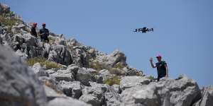 A member of the search team flying a drone on Symi as part of the search for Mosley.