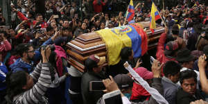 Anti-government protesters carry a coffin containing the remains of indigenous leader Inocencio Tucumbi,who protesters say died during the country's unrest. 