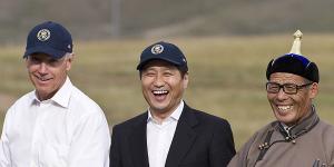 Then US vice president Joe Biden,standing next to then Mongolian prime minister Sukhbaatar Batbold,tries archery in Mongolia.