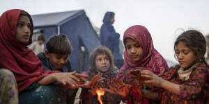 Afghan refugee children warm themselves with fire in a camp near the Pakistan-Afghanistan border. It’s almost winter in Afghanistan – when temperatures in some areas regularly plummet to as low as minus 20 degrees.