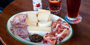 Negroni in a can,beer and a tasting cheese and meat plate.