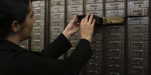 Still in demand:Commonwealth Bank flagship branch manager Diana Shekari shows one of the few vacant safe deposit boxes inside the historic vault.