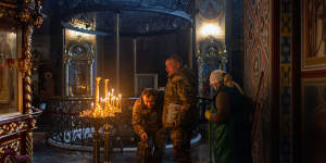 Worshippers in Kyiv’s gold-domed St Michael’s pray for a peaceful resolution. 