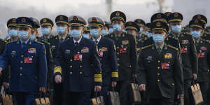 Military delegates arrive to attend the opening session of China’s National People’s Congress on Sunday.