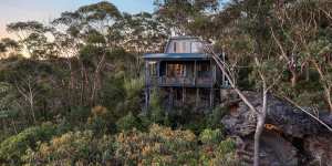 The two-bedroom Springwood house sits among the gum trees of Blue Mountains National Park.