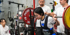 Dori Qu,22,competing in a recent powerlifting competition.