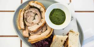 Wood-oven roasted porchetta with red cabbage and salsa verde.