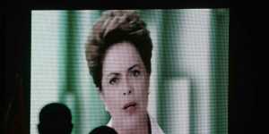 People watch a speech by Brazilian President Dilma Rousseff broadcast on the Workers Party's television program on Thursday evening.