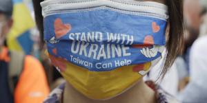 A Taiwanese woman wears a Ukraine flag-patterned mask during a march in Taipei.