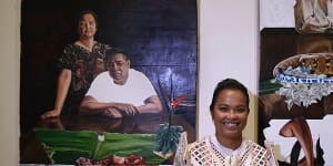 Marikit Santiago with her winning paintings ‘A Seat at the Table (Magulang)’ and ‘A Seat at the Table (Kapatid)’.