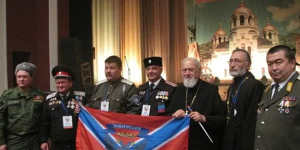 Boikov with priests and officials in Russia in 2015 holding the flag of Novorussia,an unrecognised area of southern Ukraine that Russia claims.