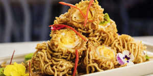 Deep-fried quail egg wrapped with egg noodle.