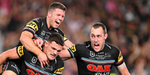 Nathan Cleary of the Panthers celebrates with teammates after scoring the match-winning try.