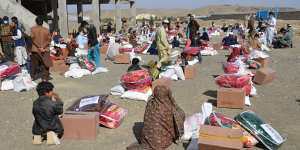 People receive relief supplies from aid agencies in Khost province,east Afghanistan,last November,ahead of winter. 