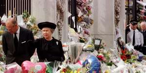 The Queen and Duke of Edinburgh look at the mass of floral tributes laid outside Buckingham Palace in memory of Diana after her death in 1997. 