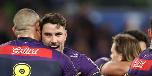 Trent Loiero of the Storm hugs Nelson Asofa-Solomona (No.8) after their club’s preliminary final win.