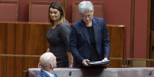Greens senator Sarah Hanson-Young walks past independent senator David Pocock and Foreign Minister Penny Wong in the Senate on Thursday.