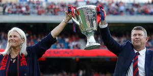 High point:Melbourne president Kate Roffey and CEO Gary Pert show off the premiership cup at the MCG in March.