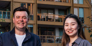 Residents Thomas Pospieszny and Nancy Chen outside their building,a Mirvac build-to-rent property at Sydney Olympic Park.