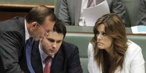 Then opposition leader Tony Abbott talks with Peta Credlin and Andrew Hirst during question time in 2012. 