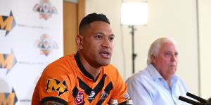 Israel Folau,pictured with backer Clive Palmer,said on Friday he was excited to return to the “grassroots level”.