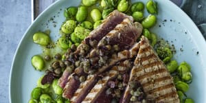 Barbecued tuna steaks with broad beans and olive tapenade.