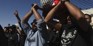 Mourners bring the body of Sohaib al-Sous,15,to the family home in Beitunia on the outskirts of Ramallah for his funeral. 