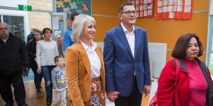 Daniel Andrews and his wife Catherine line up to cast their votes at the 2018 state election.