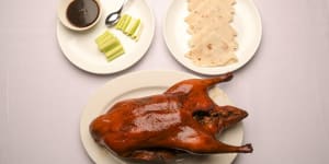 The signature Peking duck is presented tableside,then whisked off and assembled into pancakes.