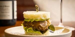 Auterra’s guanciale-draped abalone schnitzel sandwich.