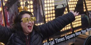 Actor Teresa Hui poses in front of the 2024 New Year’s Eve numerals are displayed in Times Square.