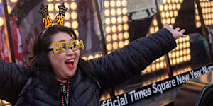 Actor Teresa Hui poses in front of the 2024 New Year’s Eve numerals are displayed in Times Square.