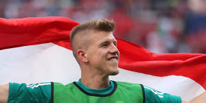 David Siger of Hungary celebrates with a flag following the draw with France.