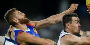 Jeremy Cameron of the Cats marks in front of Liam Jones of the Bulldogs.