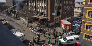 Medics and emergency works at the scene of the deadly blaze in downtown Johannesburg on August 31.