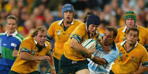 Stephen Larkham breaking the line for the Wallabies with current Rugby Australia CEO Phil Waugh in pursuit
