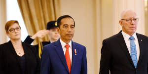 Governor-General David Hurley,right,greets Indonesian President Joko Widodo as he receives a ceremonial welcome. 