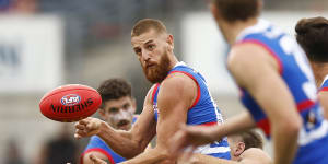 Liam Jones handballs for the Bulldogs during a practice match against North Melbourne.