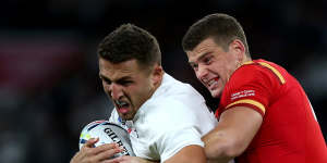 Sam Burgess is tackled by Scott Williams during the match between England and Wales.