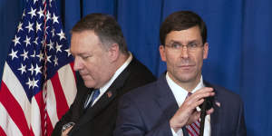 Secretary of State Mike Pompeo (left) hands the microphone to Secretary of Defence Mark Esper to deliver a statement on Iraq and Syria at President Donald Trump's Mar-a-Lago property.