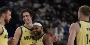 Boomers stars Josh Giddey (3) and Patty Mills (5) share a moment in their team’s win over Georgia.
