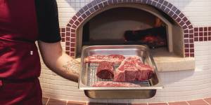 Steak,including a one-kilo bistecca,are cooked in the wood oven.