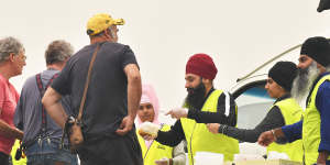 Sikh volunteers hand out meals at the Bairnsdale relief centre