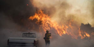 Firefighter Raymond Vasquez battles the Silverado Fire Monday,Oct. 26,2020,in Irvine,California