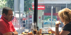 Surveillance photo of councillor Sam Aziz meeting ex-MP Lorraine Wreford in a city cafe so she could give him cash. 