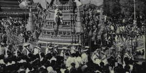The funeral procession behind the carriage taking the remains of King Ananda Mahidol moves through the streets of Bangkok.