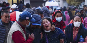 A woman cries as the body of a relative,victim of a plane crash,is brought to a hospital in Pokhara,Nepal,on Sunday.