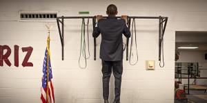 Before this photo is taken,two staffers pass the bar and do two pull-ups each. Not to be outdone,Obama does three with ease,then walks out to make a speech.