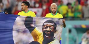 Brazil’s Neymar and Marquinhos hold a banner in support of Pele at the 2022 World Cup in Qatar.